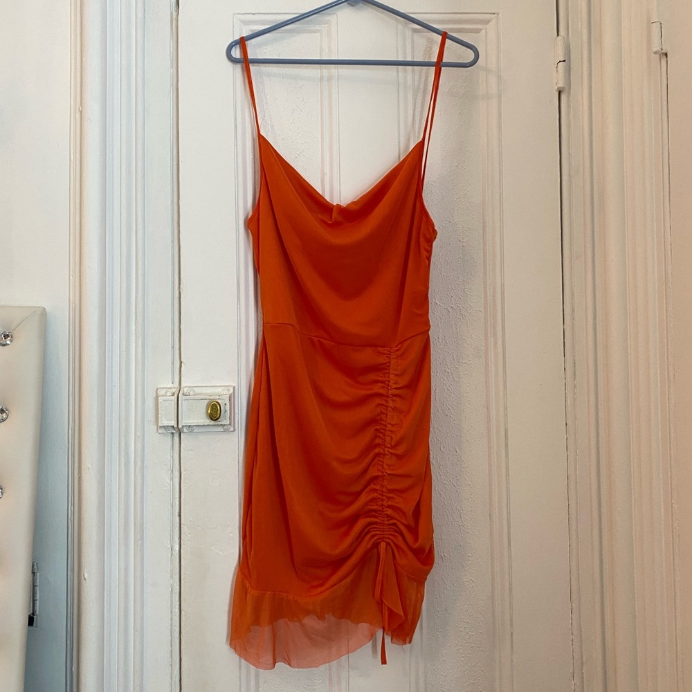 Spaghetti strap orange dress with mesh layer.
